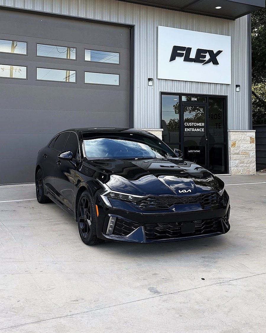 Black Kia K5 at the FLEX customer entrance